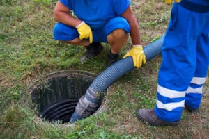 Emptying household septic tank.